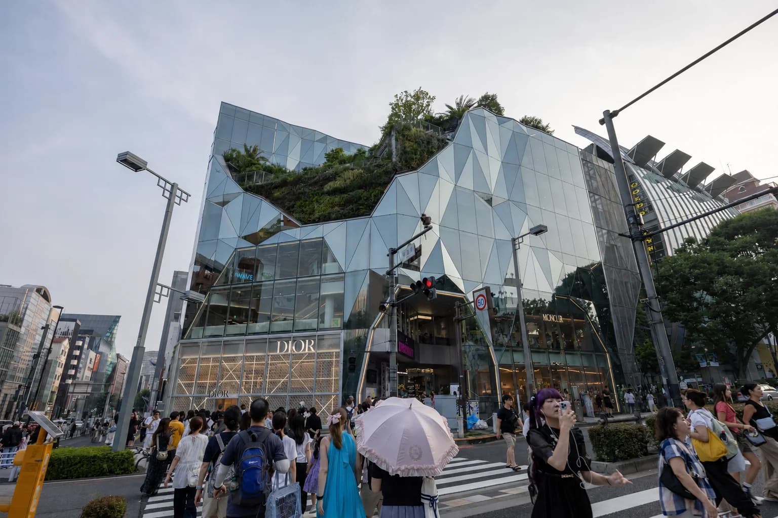 La fachada facetada del edificio Harakado, en Omotesando, con gente pasando por delante